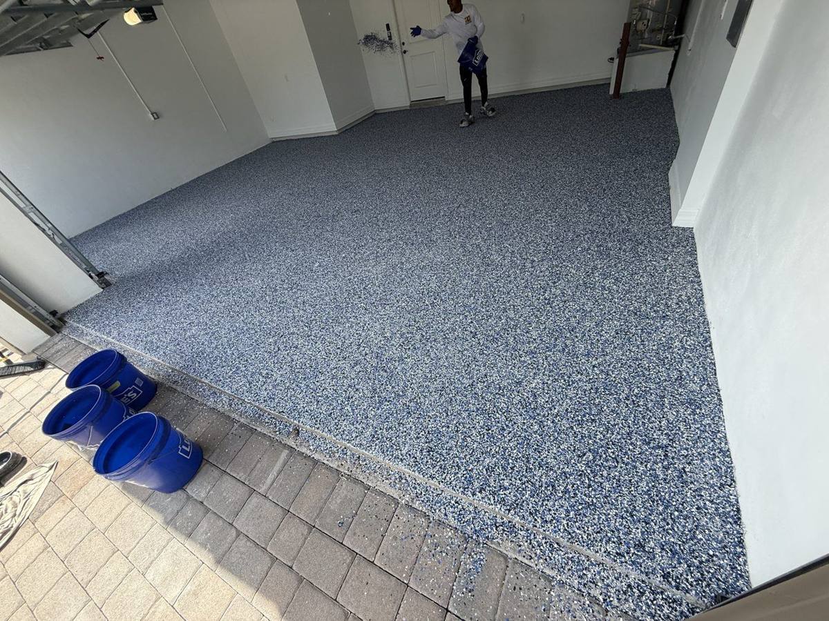 Flake epoxy floor being installed in a garage